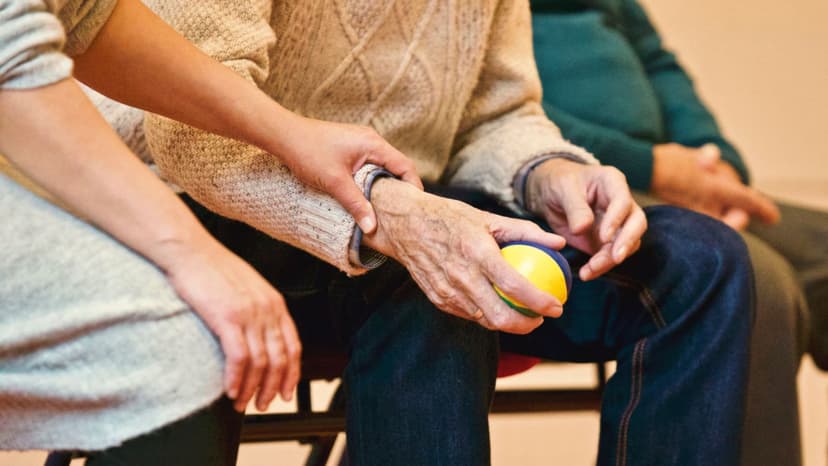 A caregiver holding a resident's hand